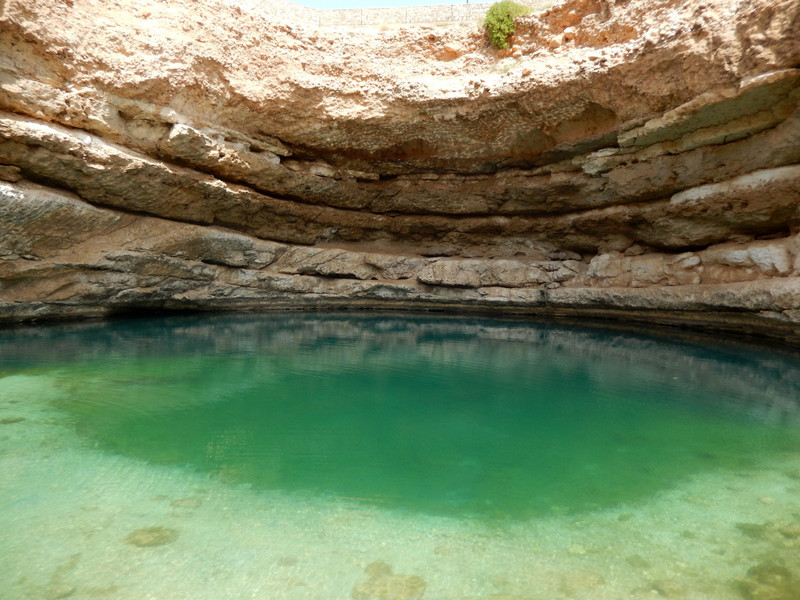 The clear green waters of Wadi Shab