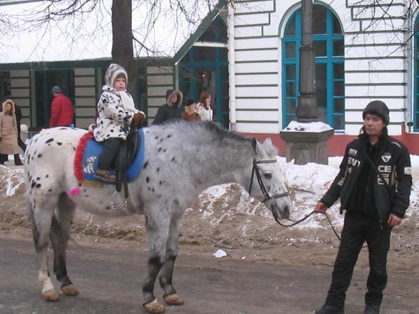 Horse rides through town during Maslenitsa.