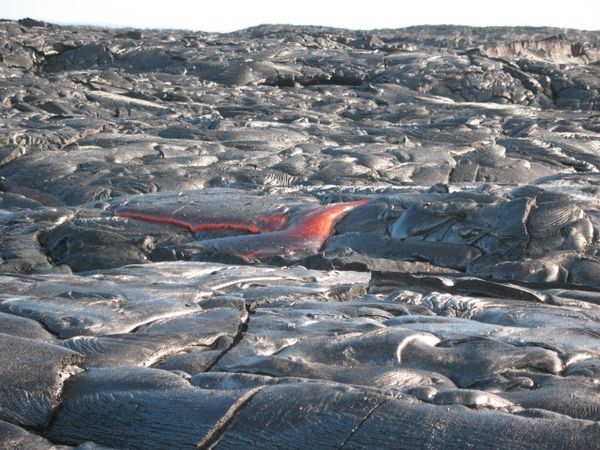 Red lava amid solidified back lava