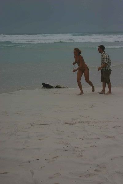Malene chasing an iguana on the beach at Tortuga bay