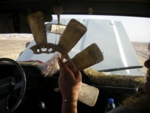 broken fan belt in the middle of the desert