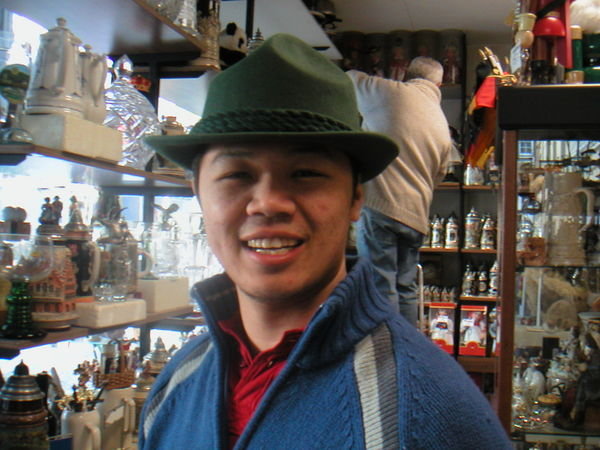 Will trying on a German hat in a souvenir shop