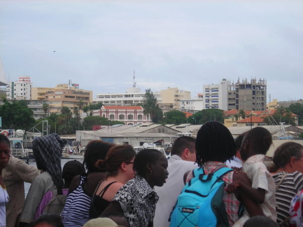 crowded ferry pulling out of the Dakar harbor