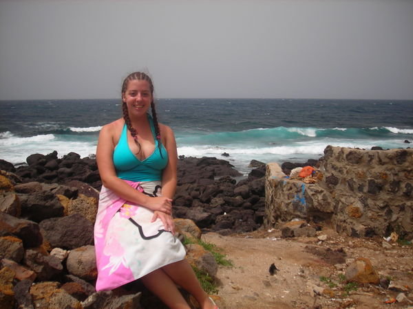sitting on lava rocks on the non-beach side of the island