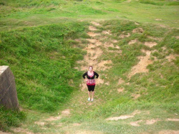 standing in an Allied crater, La Pointe-du-Hoc
