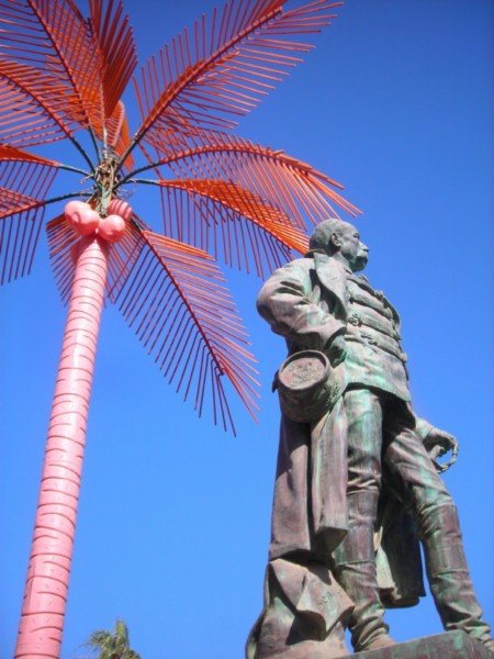 Faidherbe in front of his plastic, light-up, bright orange palm tree