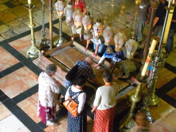 pilgrims around the stone representing where they laid out Jesus' body
