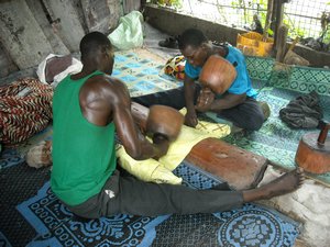 men pounding bazin fabric, Malian Market