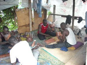 men pounding bazin fabric, Malian Market