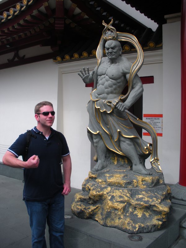 Chris, trying to be as badass as the statue outside of the Buddha Tooth Relic temple
