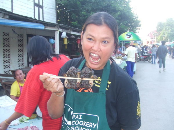 Our teacher at the food market - pretending to eat frogs