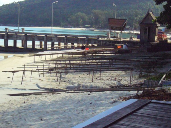 Chaloklum Beach Pier and stinking drying fish
