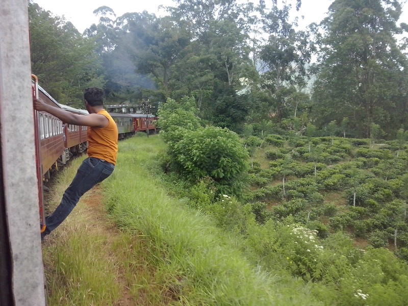 swinging from train door as it travells along