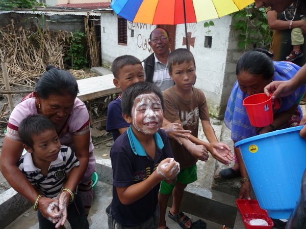 Teaching the children to wash face and hands