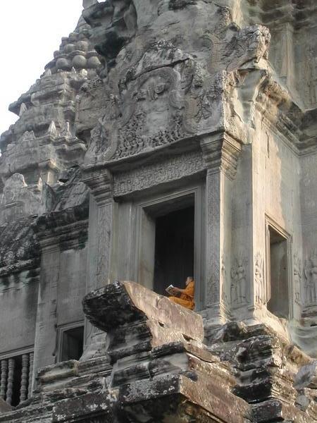 Monk reading his newspaper on Angkor Wat