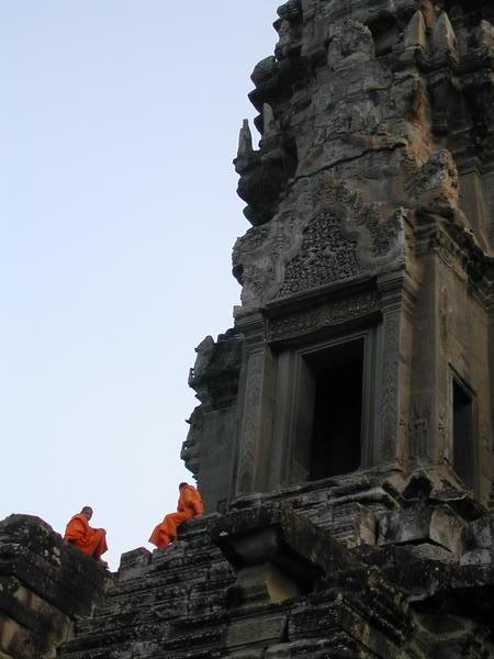 Monks perched on Angkor Wat