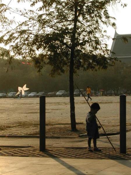 Boy playing in park opposite Grand Palace, Bangkok