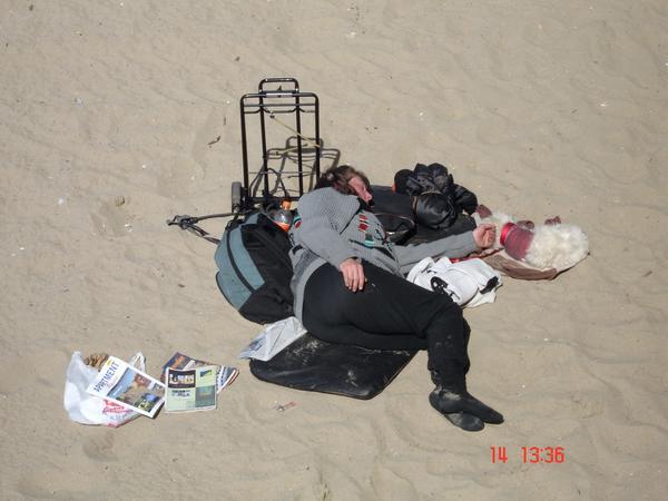 Homeless woman on sand