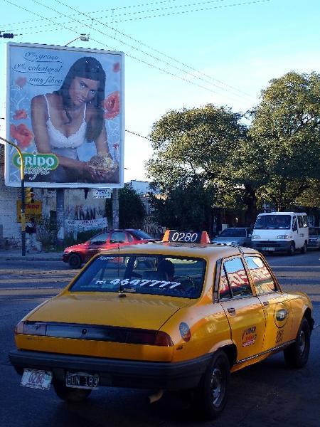 Advert and taxi on Mons. Pablo Cabrera, Cordoba