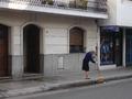Lady sweeps pavement near Central Cordoba