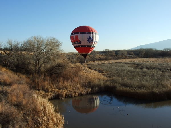 The red balloon coming in low over the swamp.
