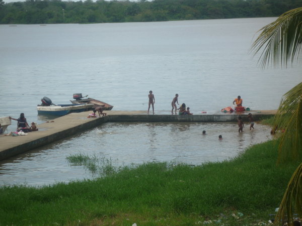 Local children bathing, washing and cleaning.
