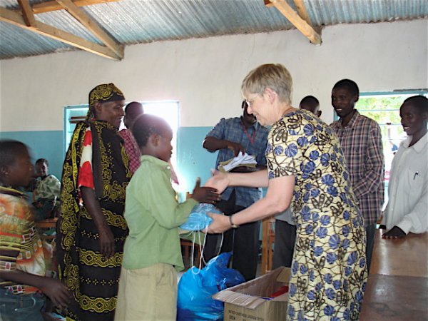 Gerry presenting school supplies to one of 'the kids'.