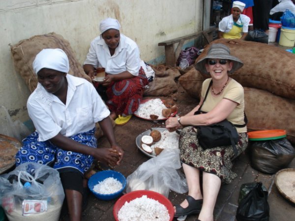 These ladies invited Gerry to try her hand at shredding coconut.