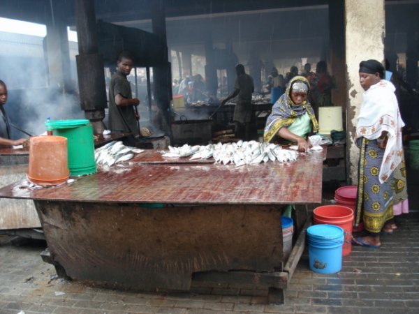 This is the cooking building where the fish are deep fried in large woks over charcoal fires in preparation for sale on the street.