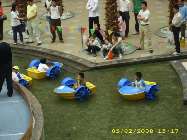 cute kids in boats in the mall!