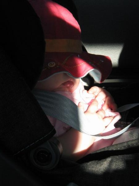 Beth asleep in her car seat in the black cab on the way from Heathrow to London.