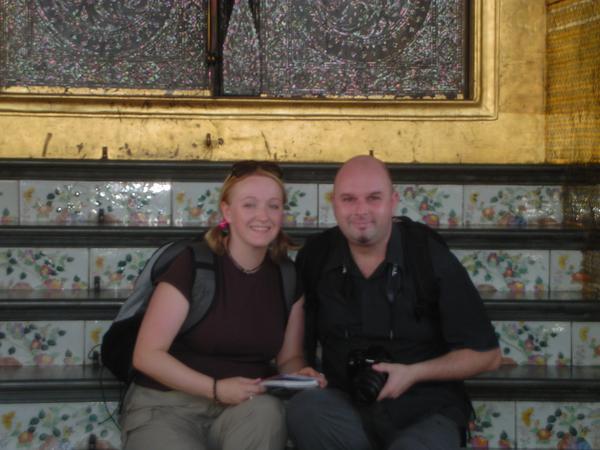 Shaz and Alan relax on the steps outside the Temple of the Emerald Buddha