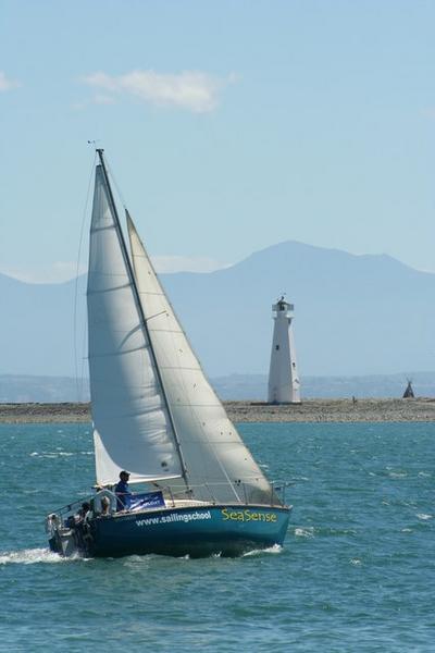 Tight sails and a lighthouse