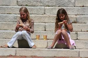 2 wee lassies enjoying their lunch on the steps of Nelson Cathedral