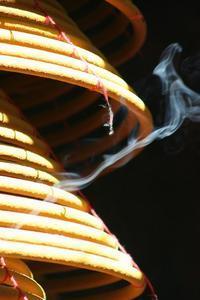 Burning incense coils outside a temple