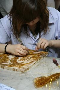 This girl is making a Cloisonne  picture
