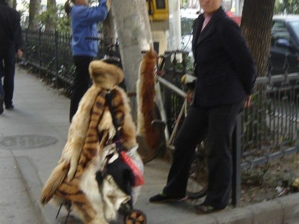 Woman selling animal pelts on the street.