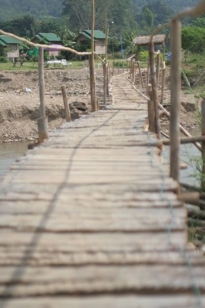 Footbridge to hut village