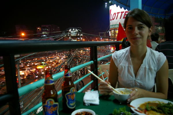 Ashlee Eating Dinner with busy Saigon traffic in background