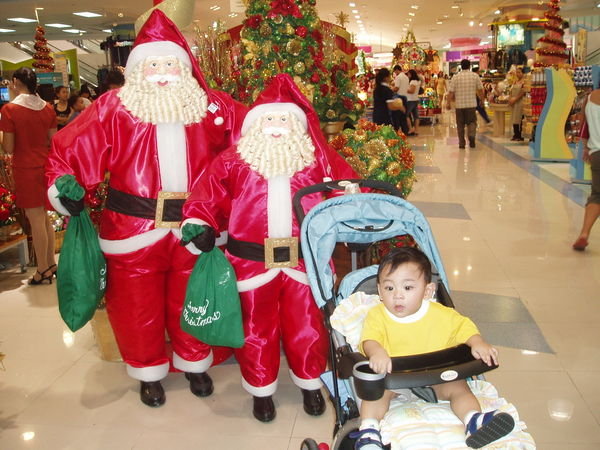 Adriel with the two Santas