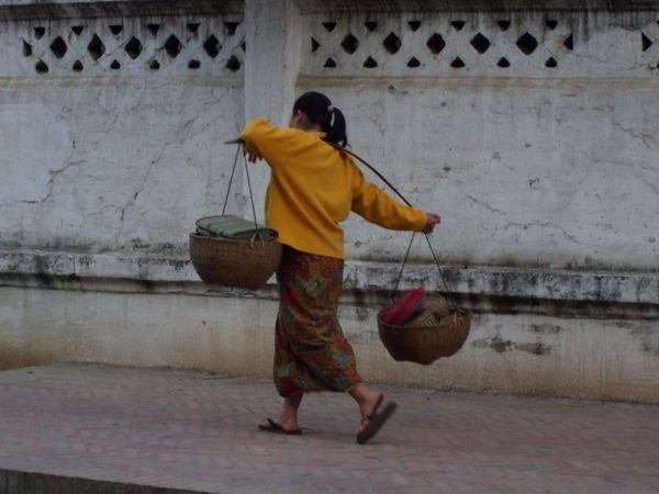 Local woman walking around with food etc for sale