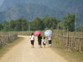Laos women from the local village using umbrellas to keep their skin whiter