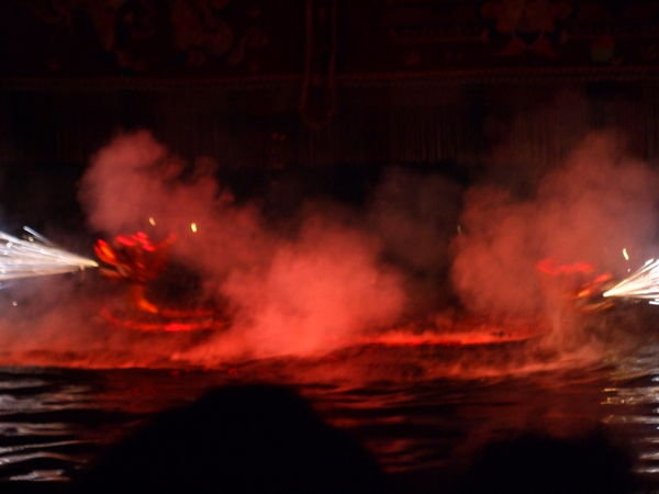 Some dragons breathing fire, during the water puppet show