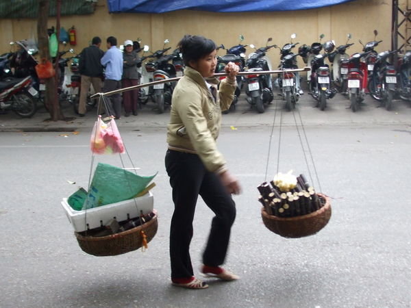One of the many street vendors that have to carry their goods around with them all day long - must be hard work!!