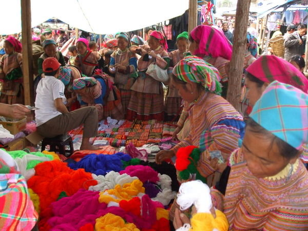 The local Flower Hmong people buying materials to create their beautiful outfits