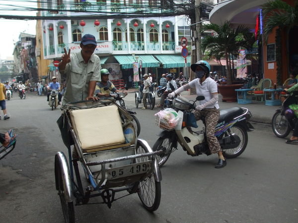 One of the many cyclo drivers roaming the city looking for customers