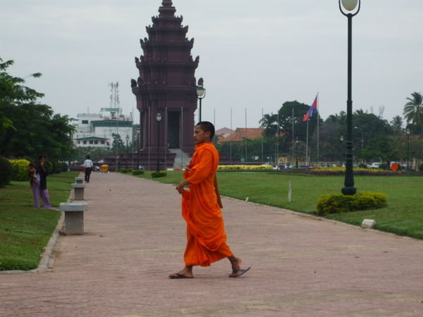 A monk walking past Victory Monument