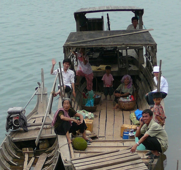 Family on their fishing boat, tied up next to the Pandaw ship