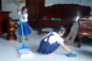 Ponheary's nieces playing with cleaning supplies