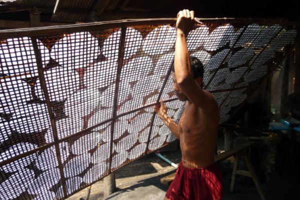 Taking the racks of rice paper out to dry in the sun